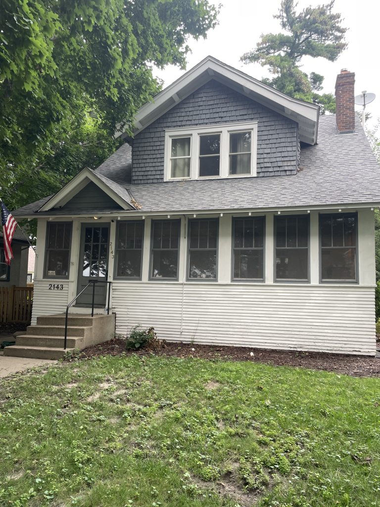 A white and blue 1.5-story house on Selby Avenue in St. Paul