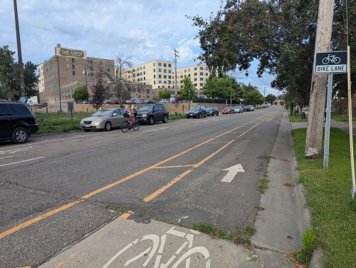 Myrtle Avenue, with a cyclist in the door-zone painted bike lane.