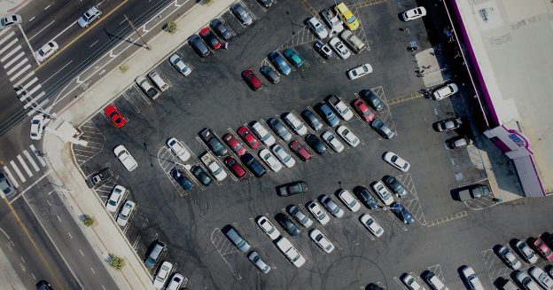 Aerial photo of a parking lot outside a dollar store.