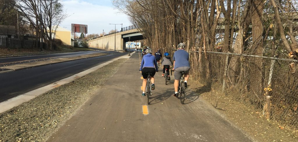 A group of cyclists riding down Ayd Mill Trail. 