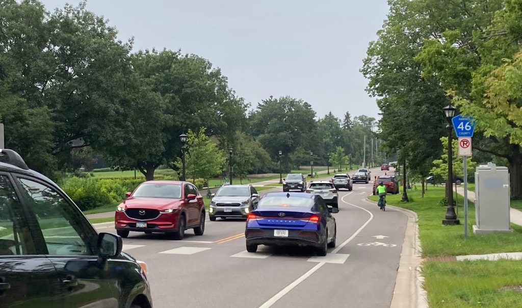 Two-way traffic on Cleveland Avenue in St. Paul during morning rush hour. One cyclist is within the painted bike lane.