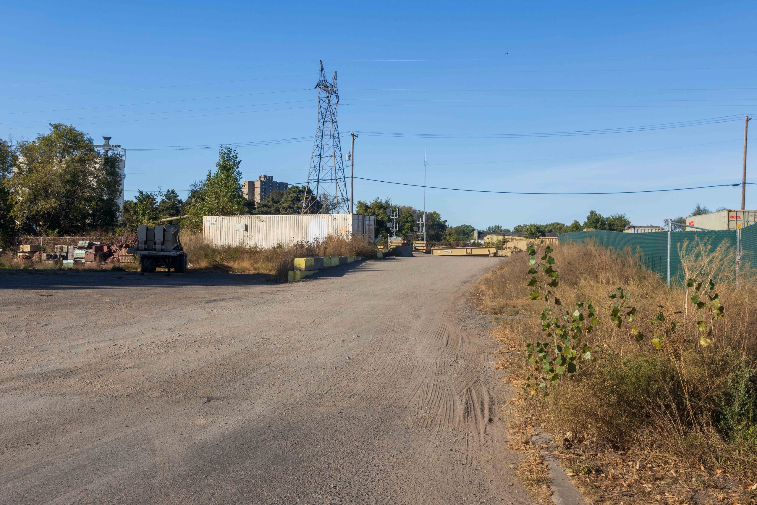 Gravel driveway/road leading toward a building.