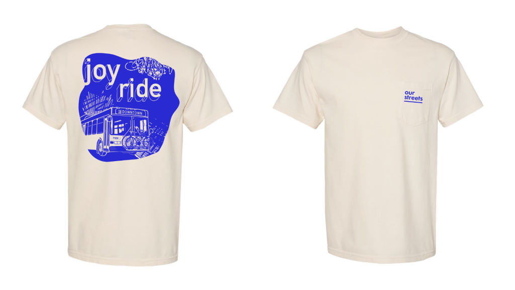 Front and back view of a cream-colored T-shirt. The back has a large blue graphic of a city bus with bicycles and the words “joy ride” in bold text. The front has a small blue logo on the pocket that reads “our streets.”