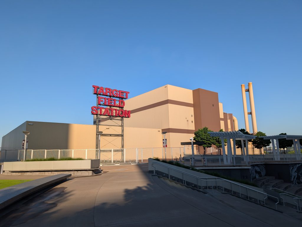 Target Field Station Sign with boxy tan and brown HERC behind it