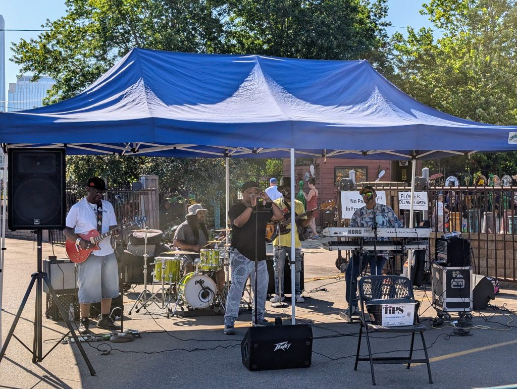 Musical ensemble performing under a tarp