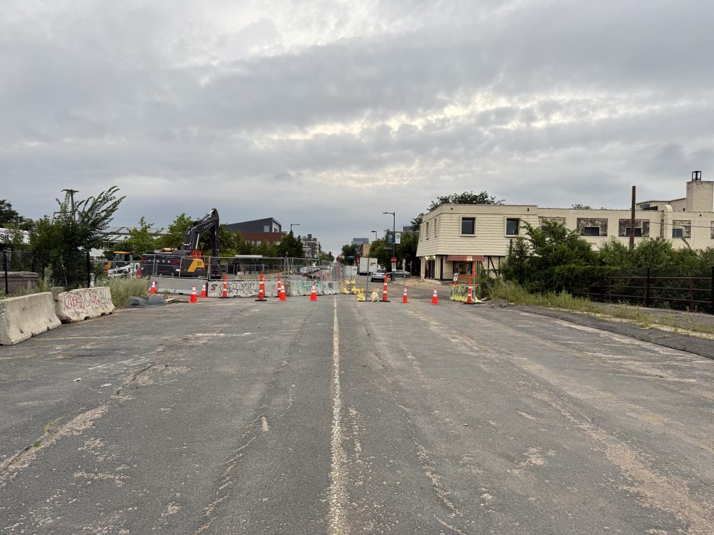 From on top of the Nicollet Ave bridge looking north, the pavement is in poor condition, with linear cracks showing where the streetcar tracks sit underneath.