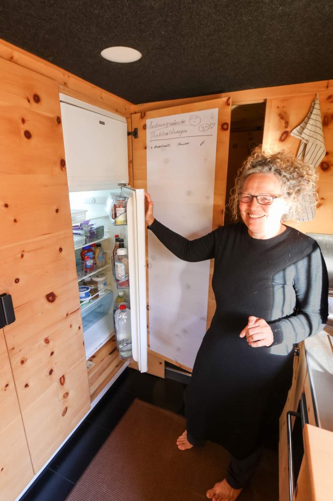 Ingrid standing next to open refrigerator