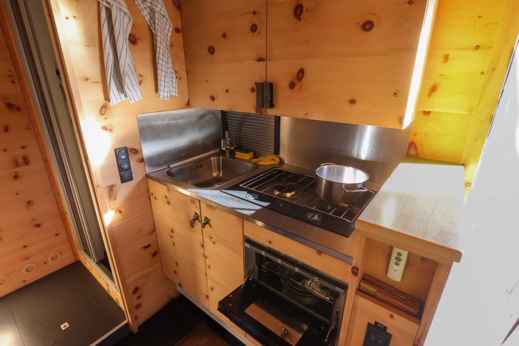 The kitchen area with the sink, stove and oven. 