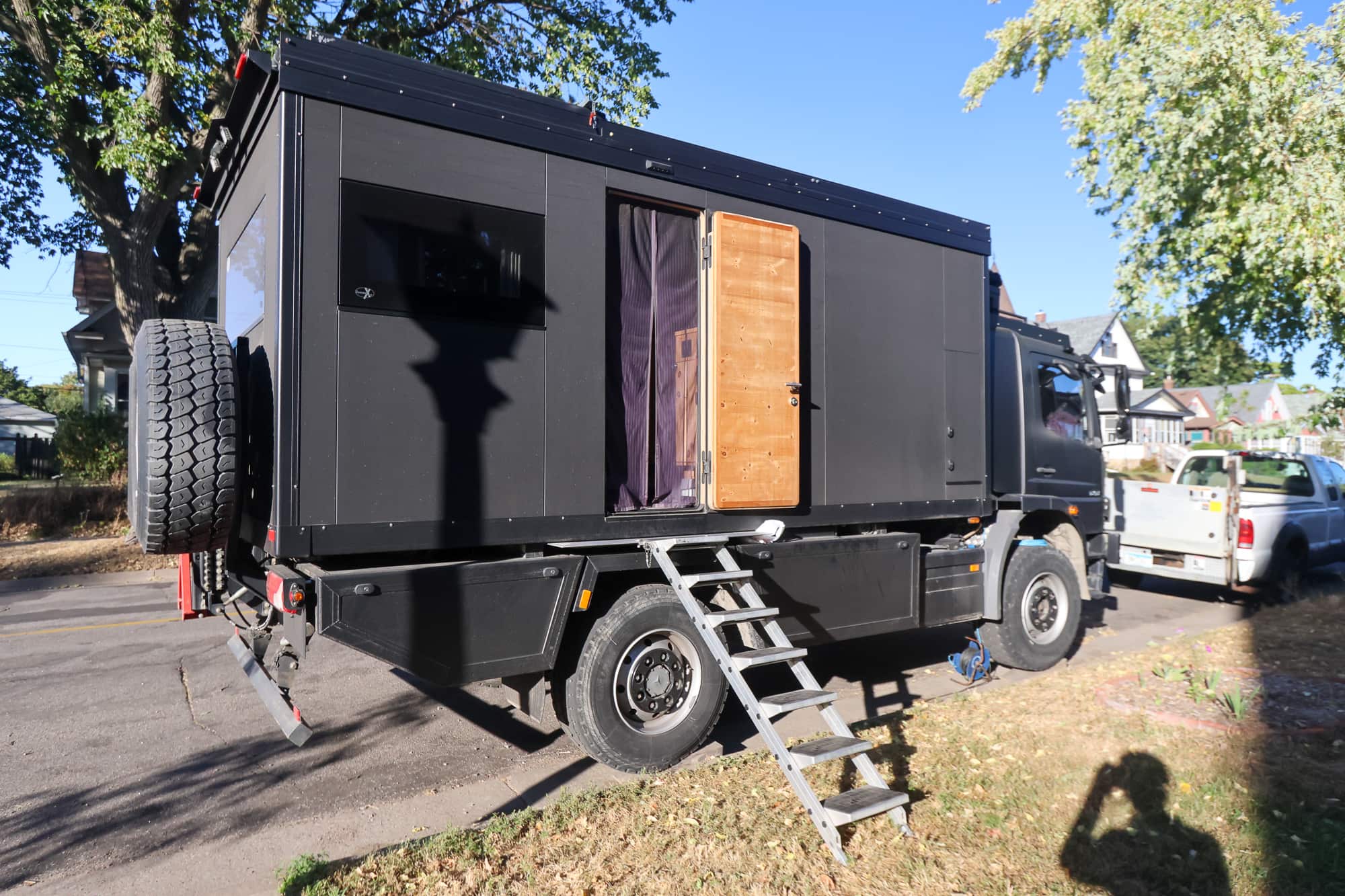 RV parked on street with door open and steps extended