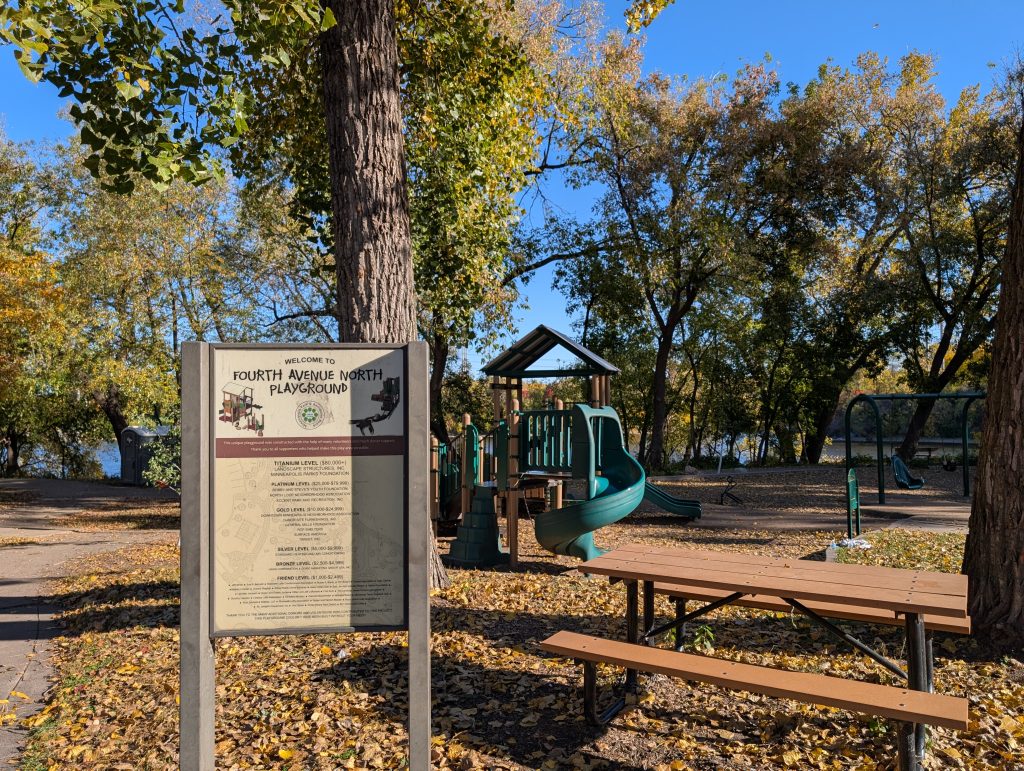 playground with trees and river in background