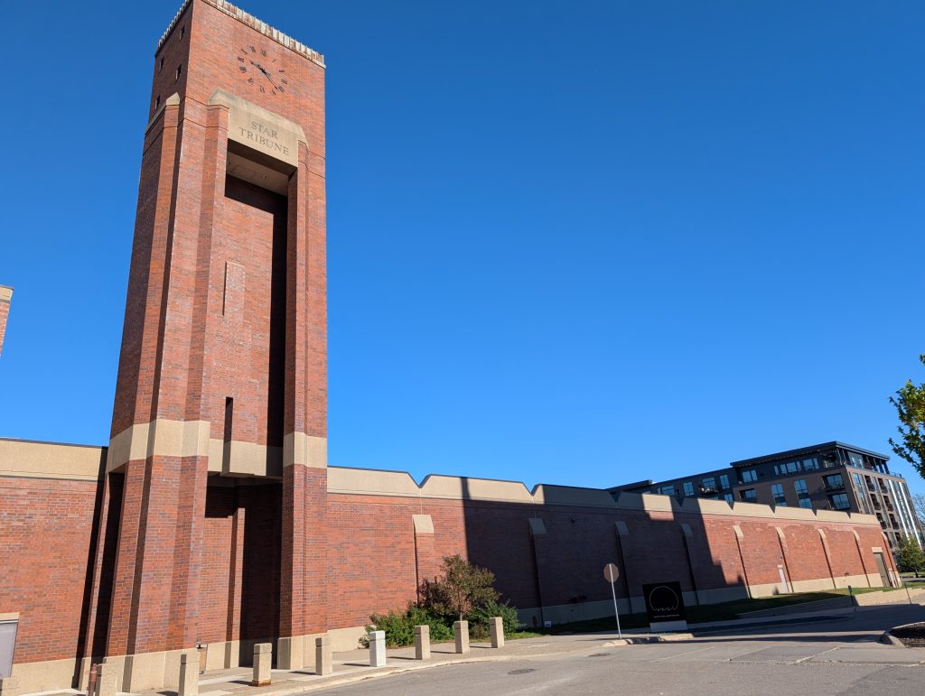 broad one-story windowless building with clock tower