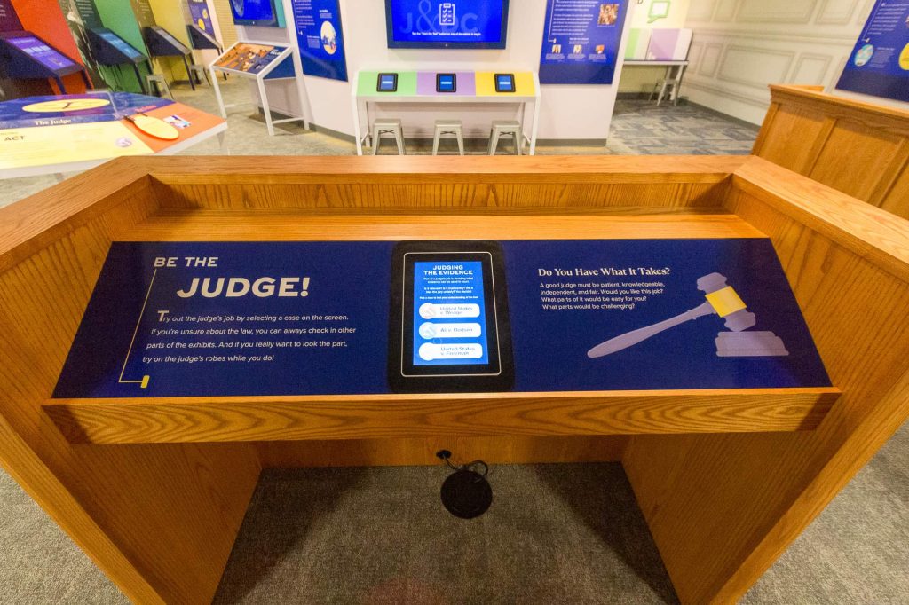 Built into the bench, an interactive display allows visitors to see how they'd rule on actual Supreme Court cases.