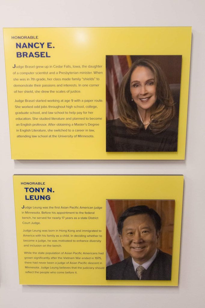 Official Photos and biographies of justices Nancy Brasel and Tony Leung on the wall.