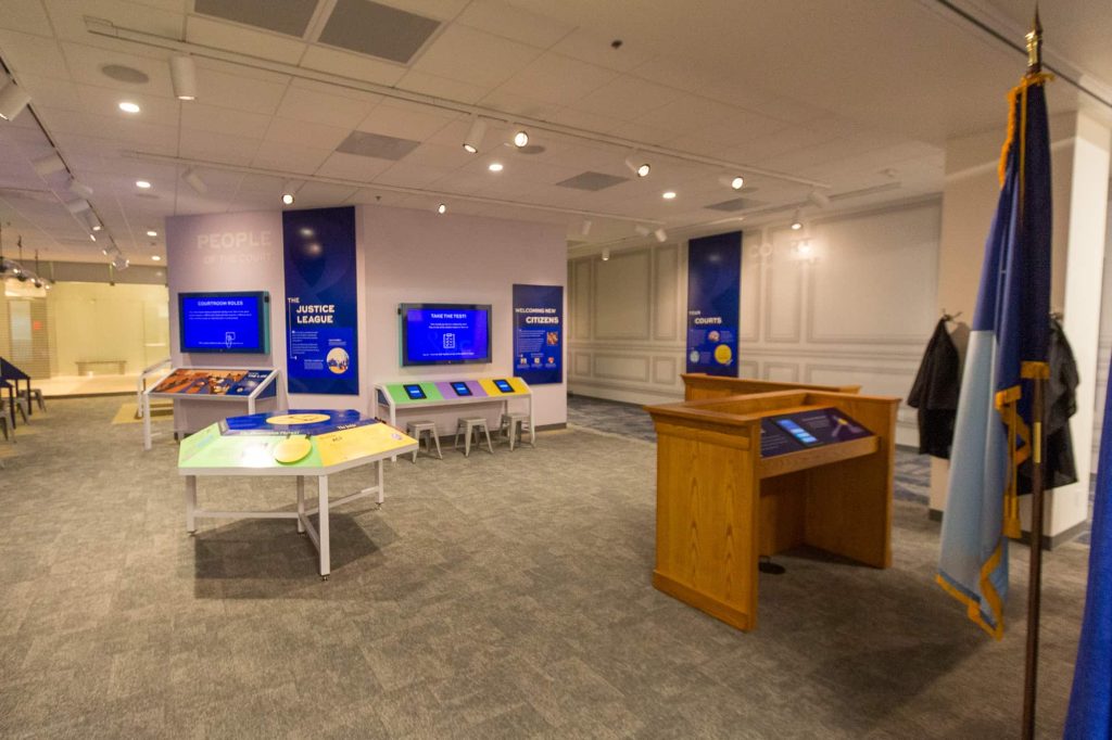 Tables and podium as part of exhibits in the Justice & Democracy Center.