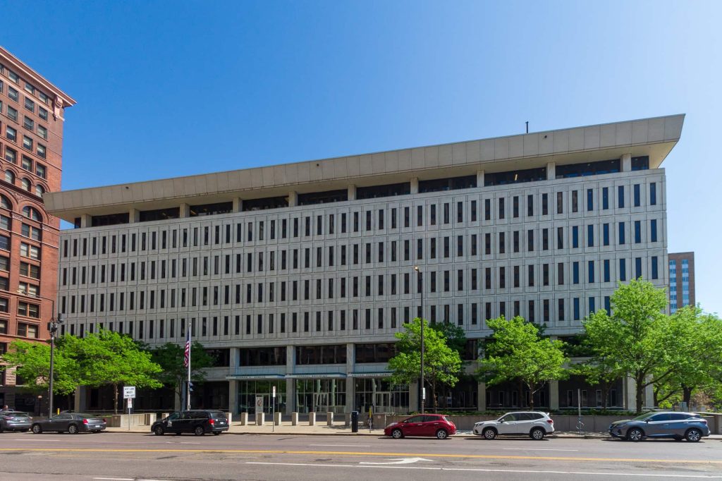 The courthouse building with its white facade and many windows.