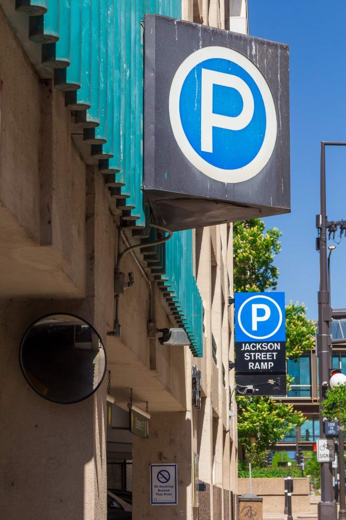 Two signs near the Jackson Street entrance of the parking ramp of the same name.