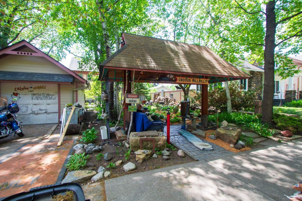 Doug and Carole's backyard and some of its treasures, including landscaping, a pagoda and several unique signs.