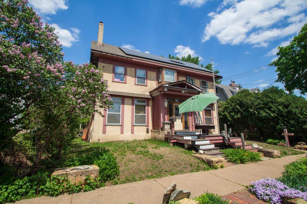 A two-level home with two sets of steps leading to the front door.