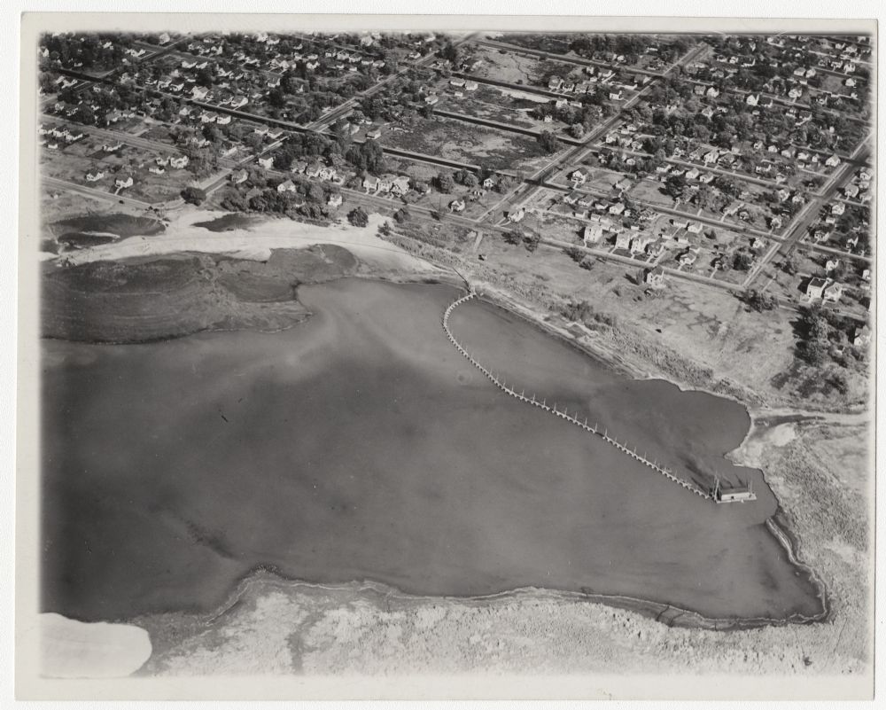 Aerial photo of Lake Hiawatha, showing dredging equipment.