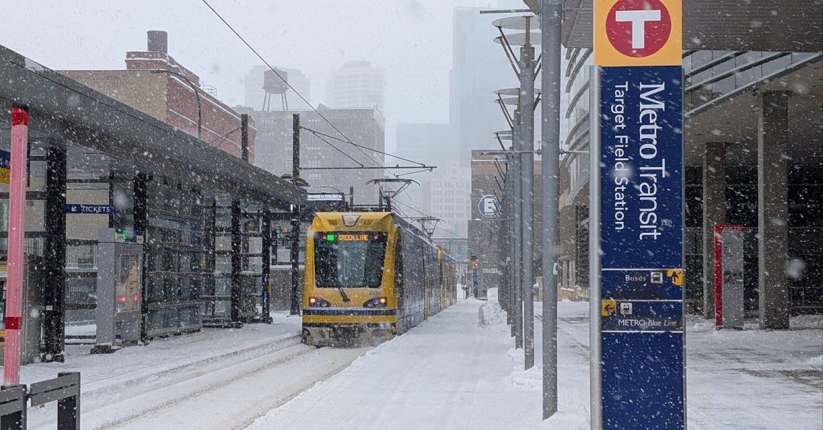 A light rail train in a snowstorm.