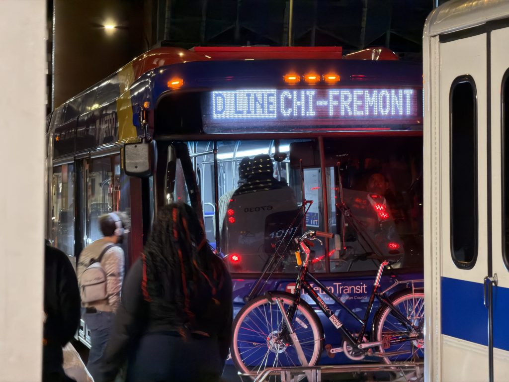 Metro Transit METRO D Line bus rapid transit arrives at 8th Street and Hennepin Avenue at night in Downtown Minneapolis