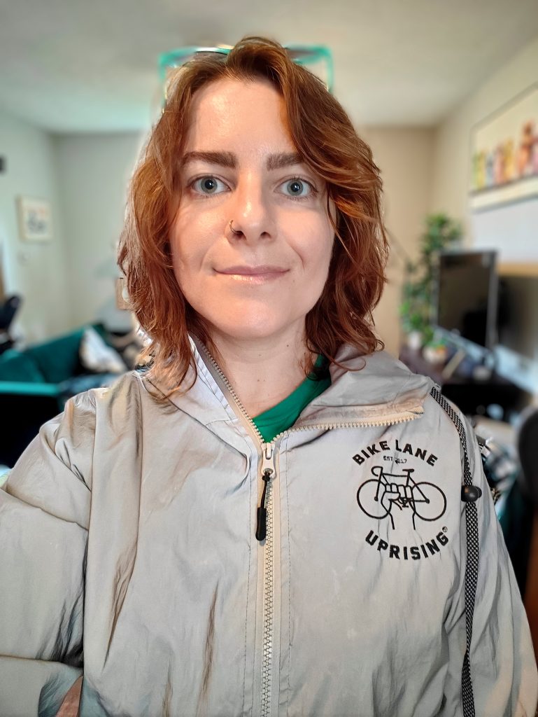 Regina wearing a reflective Bike Lane Uprising jacket