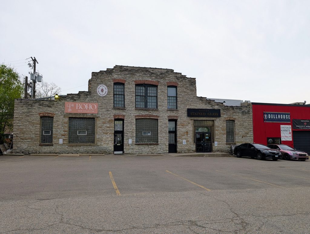 limestone building facade stepped up from one story to stwo in the center