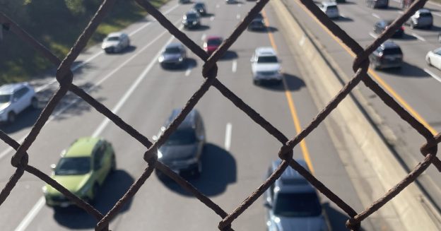I-94 seen through the chain-link fence of a walk-bridge in St. Paul. Photo: Amy Gage