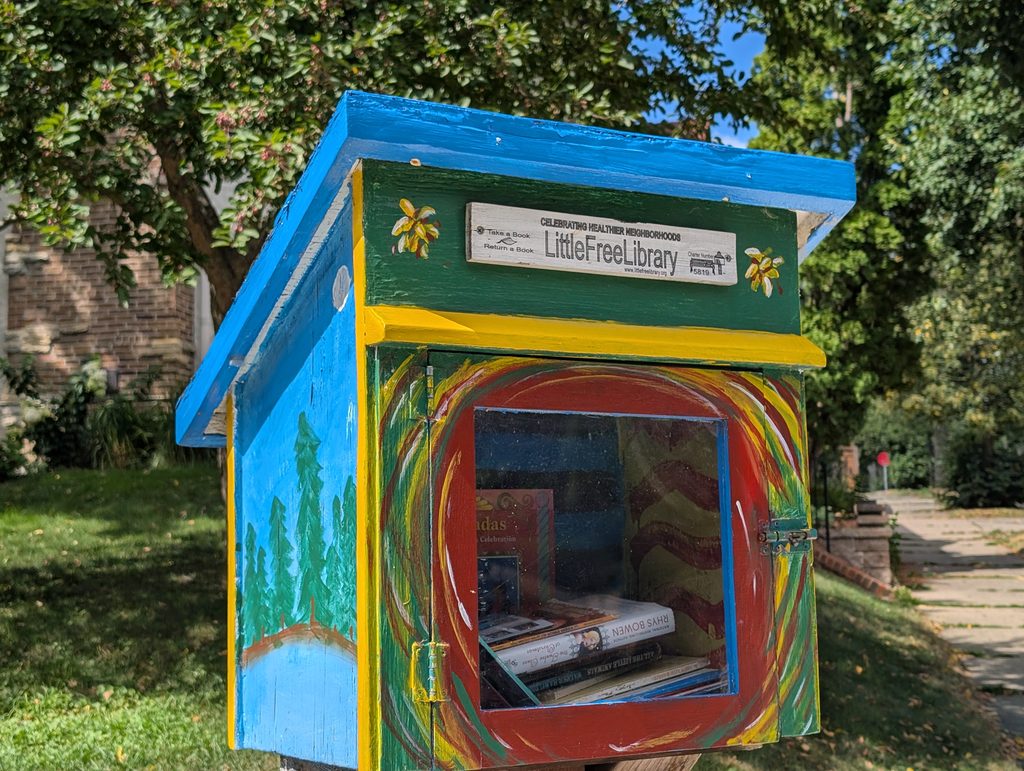 colorfully decorated little free library viewed from a front corner