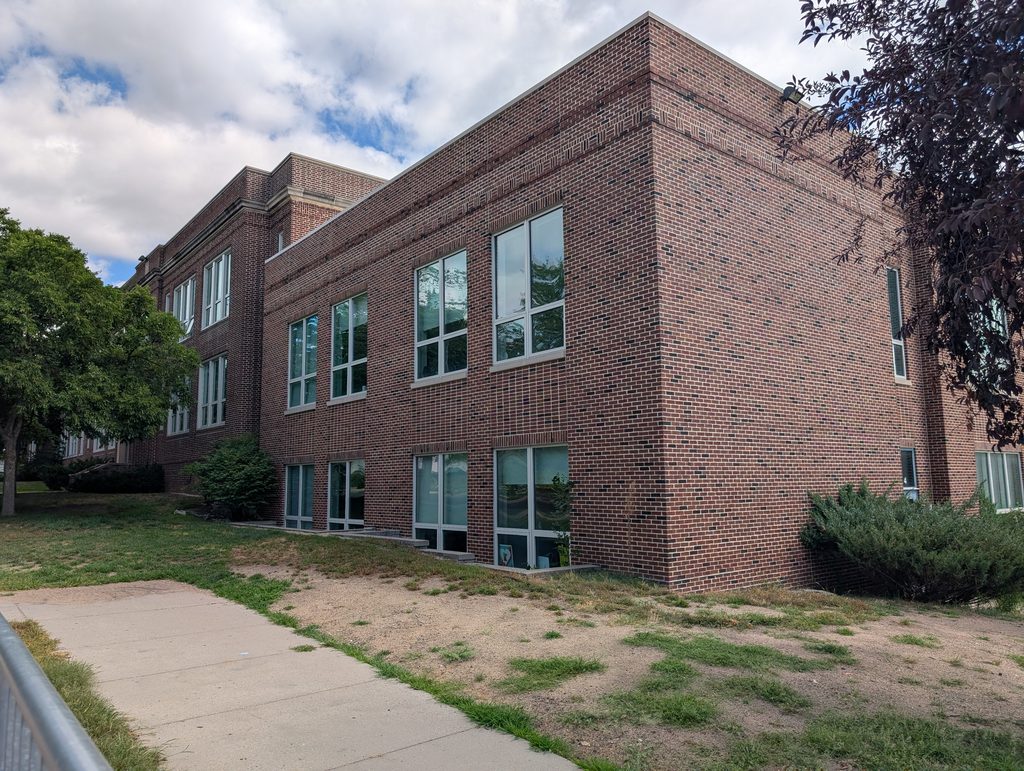 junction between older and newer segments of brick school building