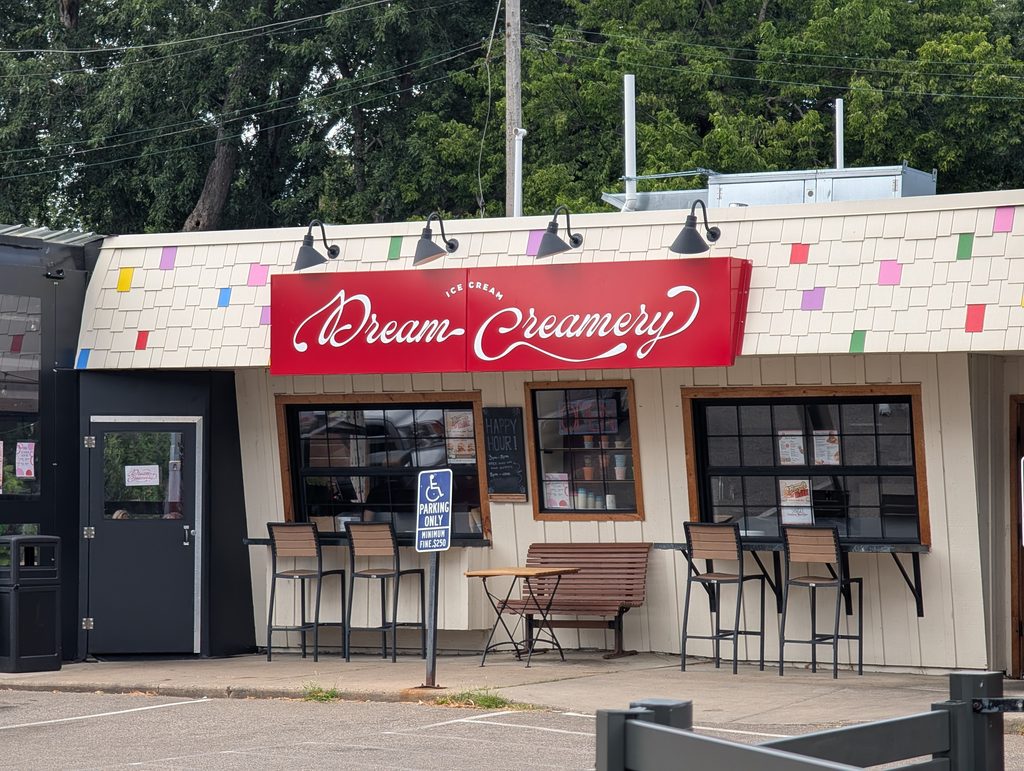 storefront with counter service windows and signage saying "Dream-Creamery ice cream"