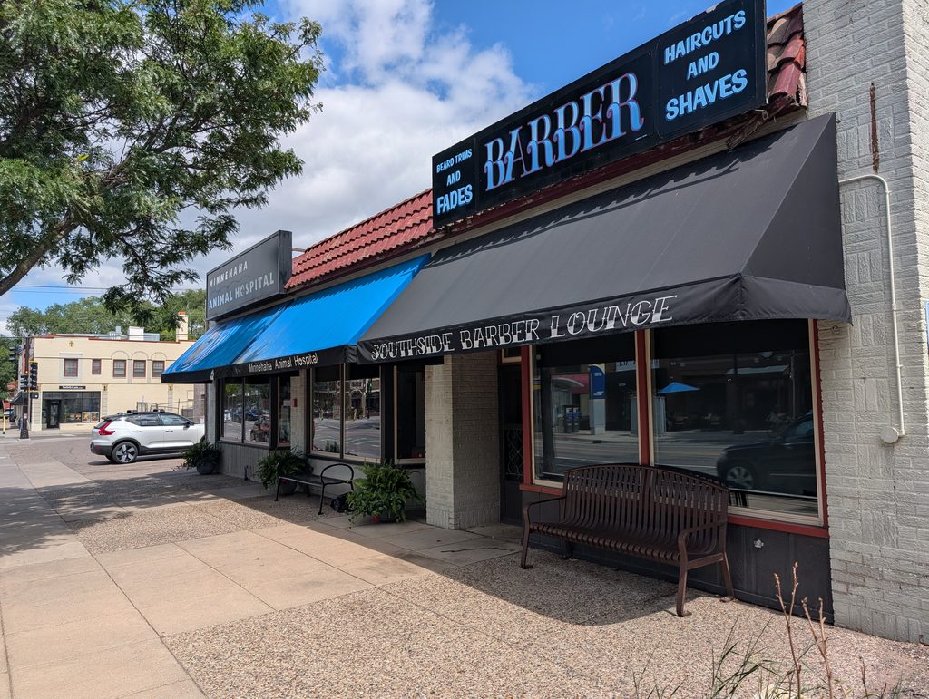 store fronts with the most prominent sign being for a barber