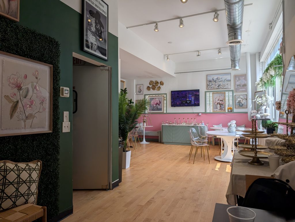 interior with track lights, pink wainscoting with green trim, and floral art and decor