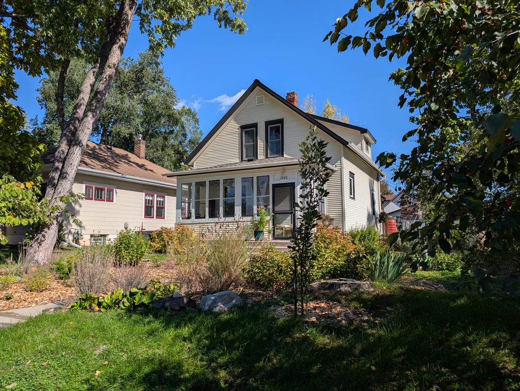 story and a half house with asymmetrical front porch